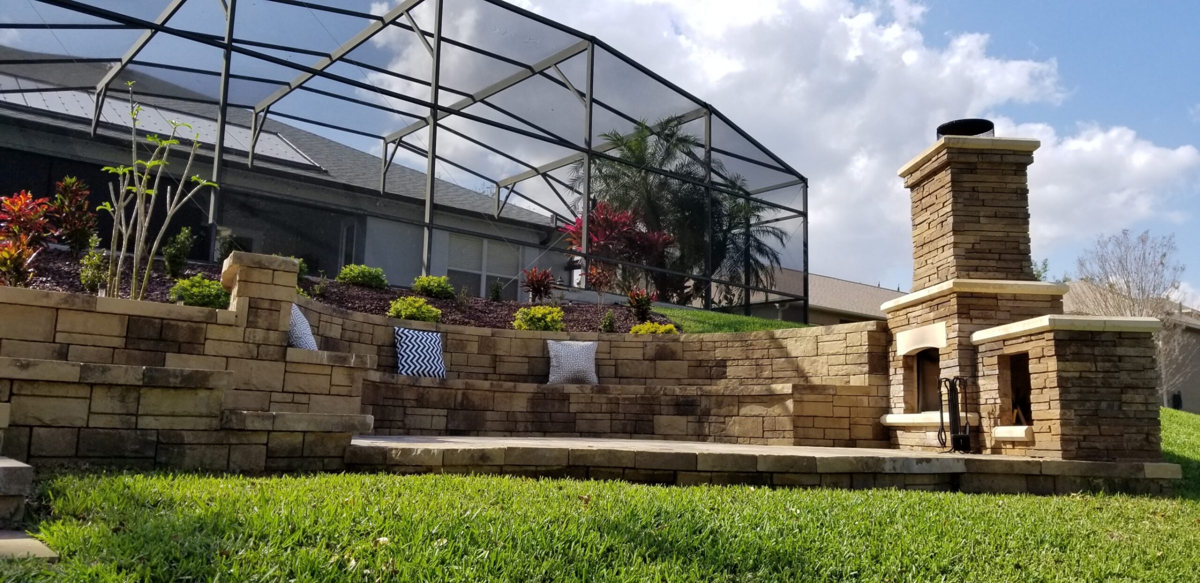 Patio with stone seating and outdoor fireplace.