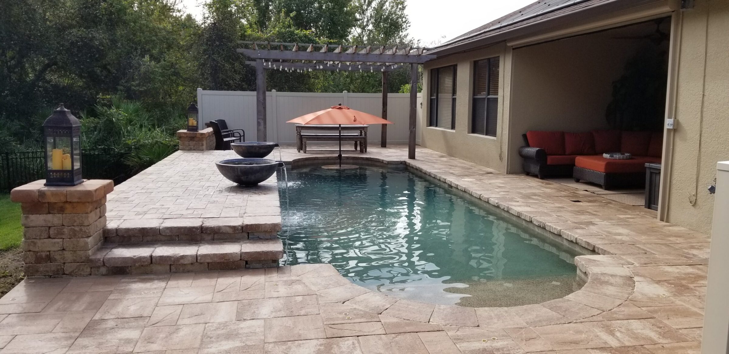 Backyard pool with patio seating and garden