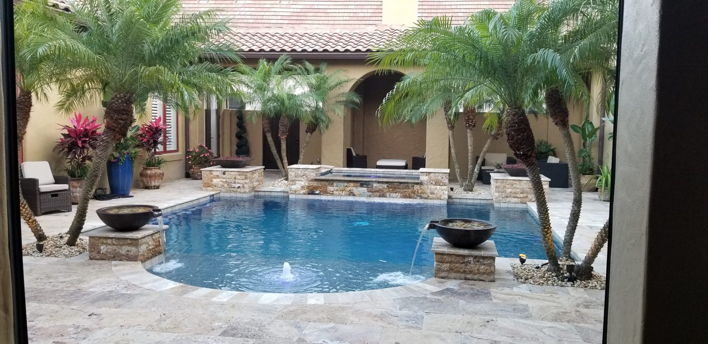 Elegant courtyard with pool and palm trees