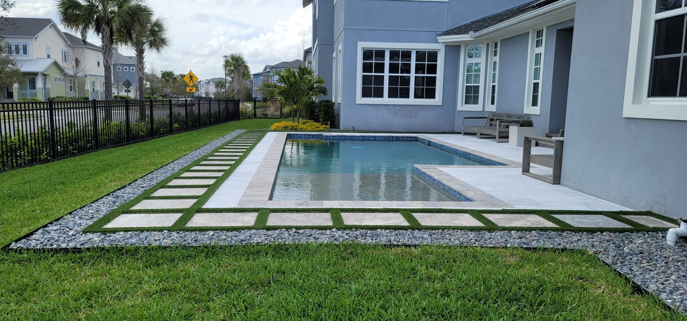 Modern backyard with swimming pool and landscaped garden.