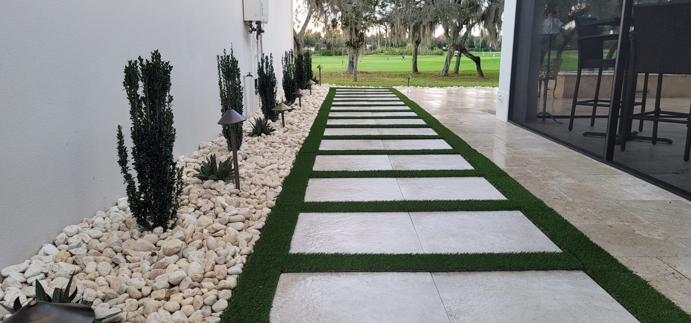 Modern garden path with stones and plants.