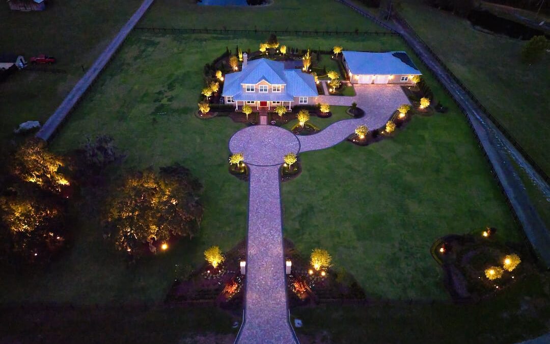 Aerial view of illuminated large house at night.