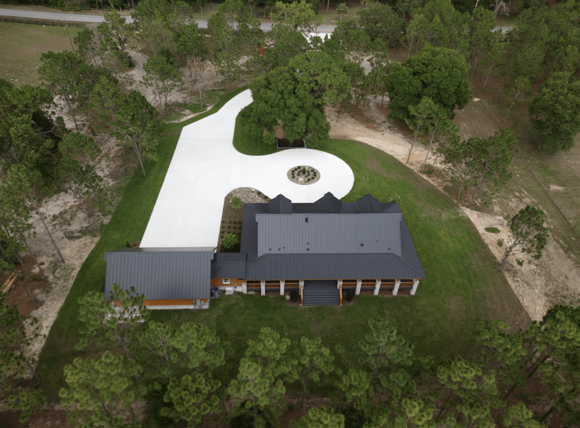 Aerial view of a large house and driveway.