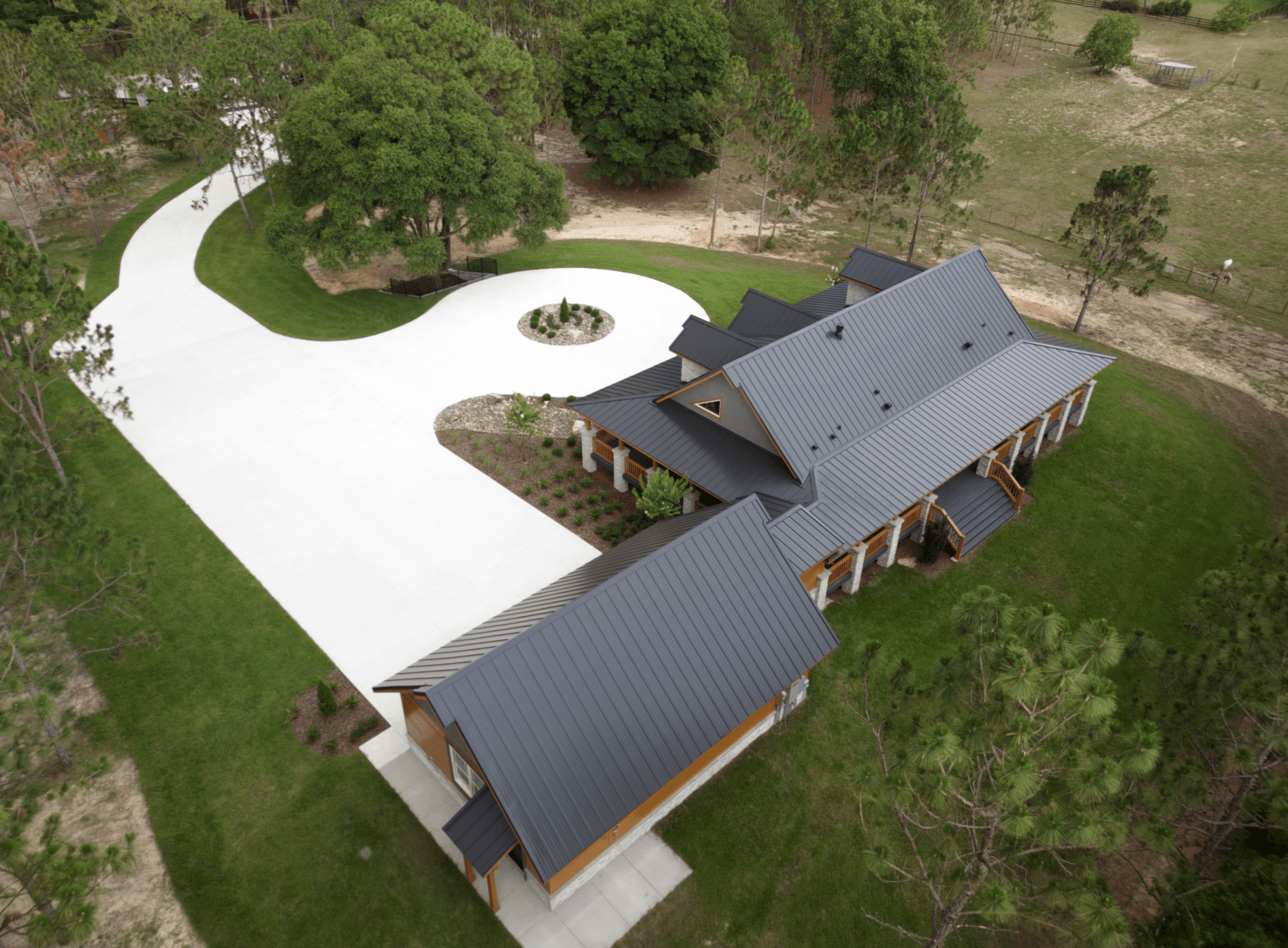 Aerial view of house with long driveway