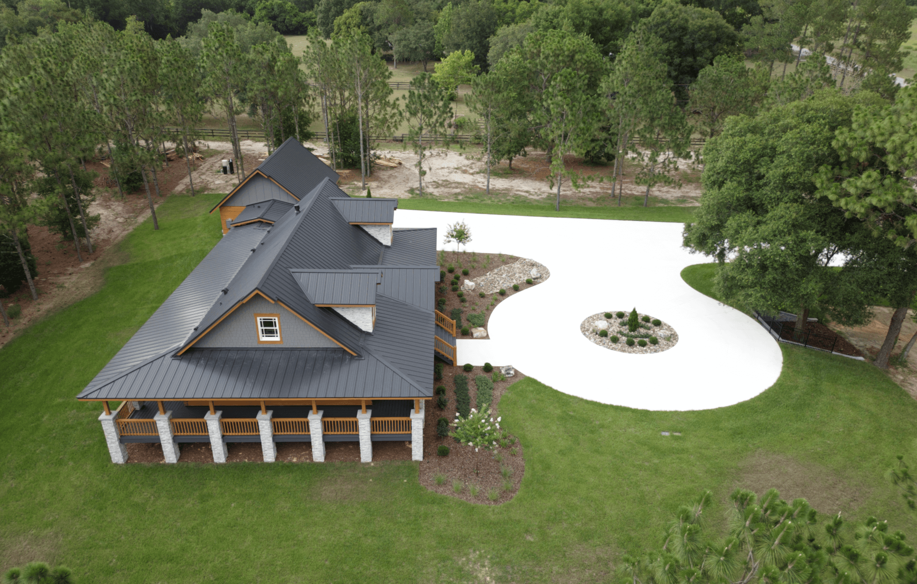 Aerial view of house with curved driveway.