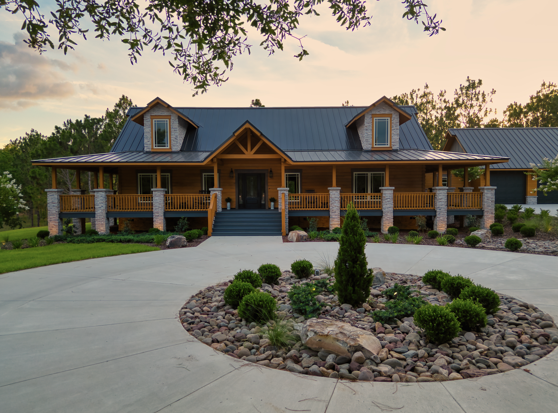 Rustic log cabin with porch at sunset