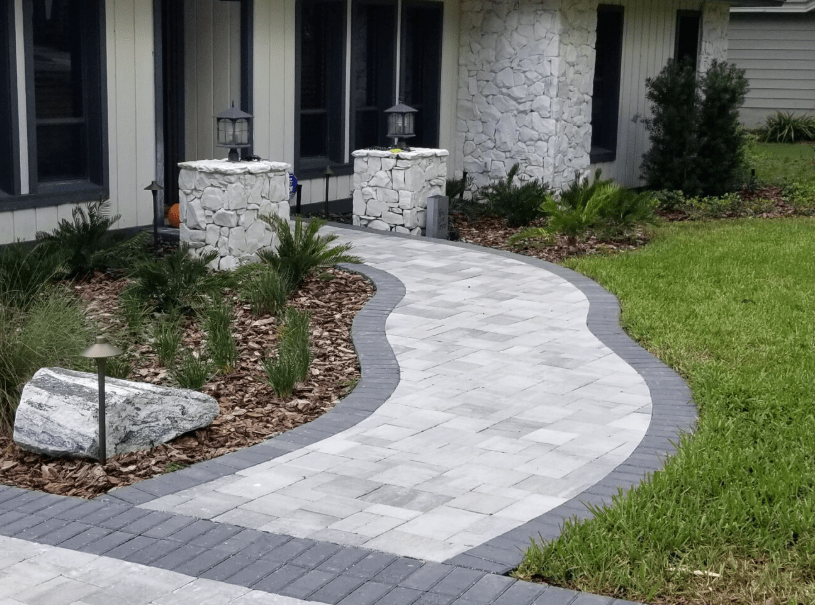 Curved stone pathway with garden and lanterns