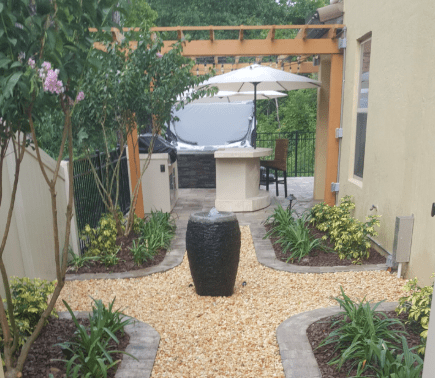 Outdoor patio with pathway, pergola, and seating area.
