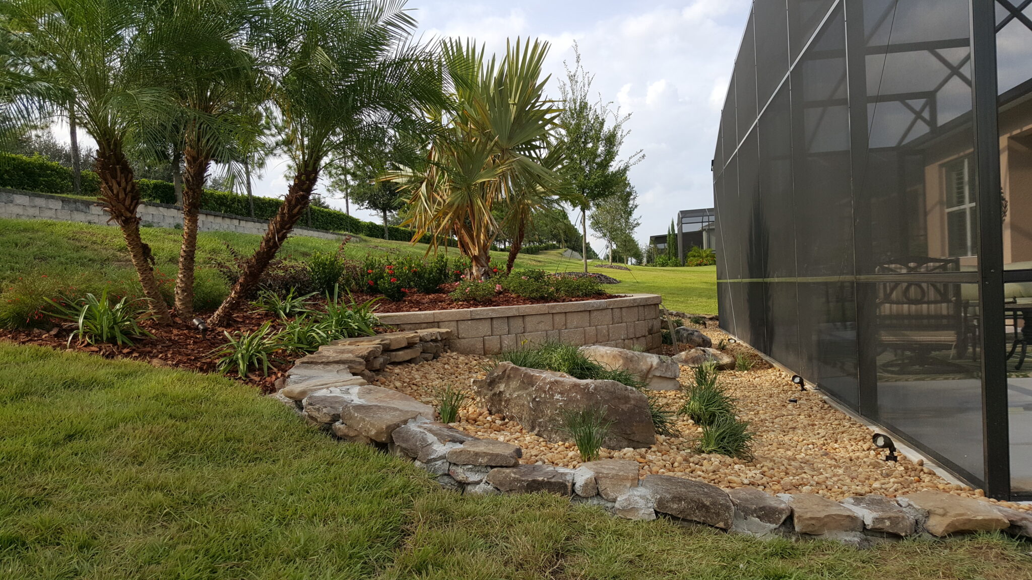 Outdoor landscaped garden with trees and rocks.