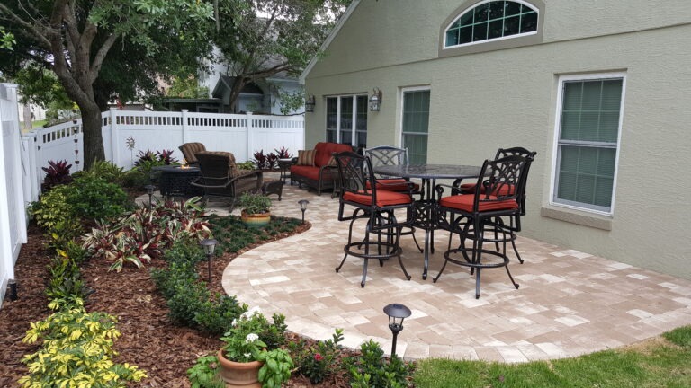 Backyard patio with furniture and garden landscaping.