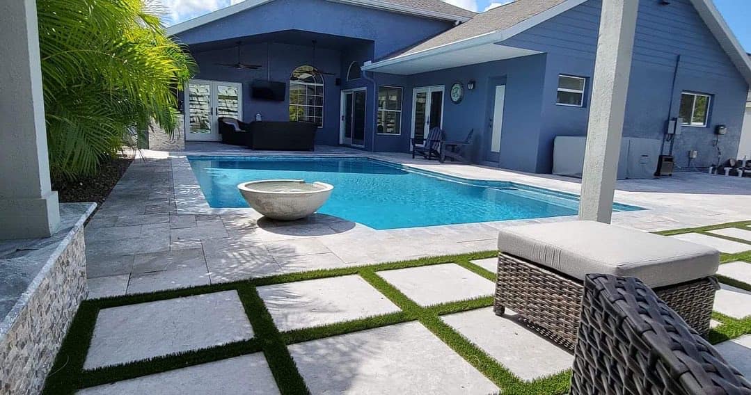 Modern backyard pool with patio furniture