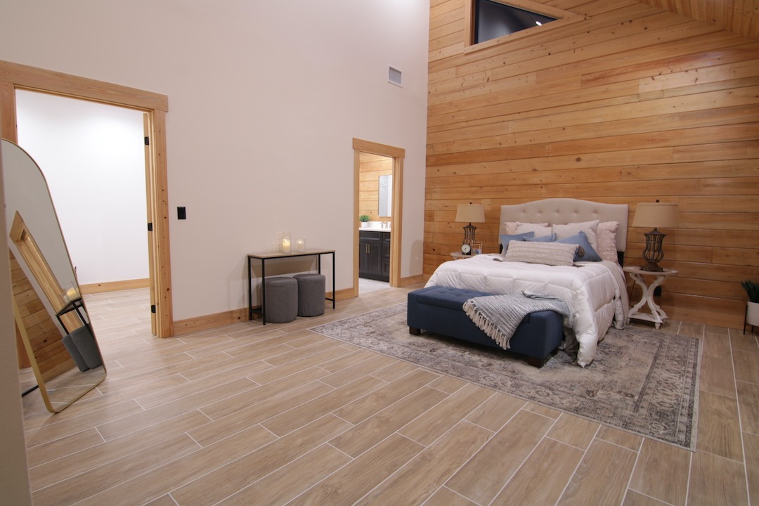 Cozy bedroom with wooden walls and modern decor.