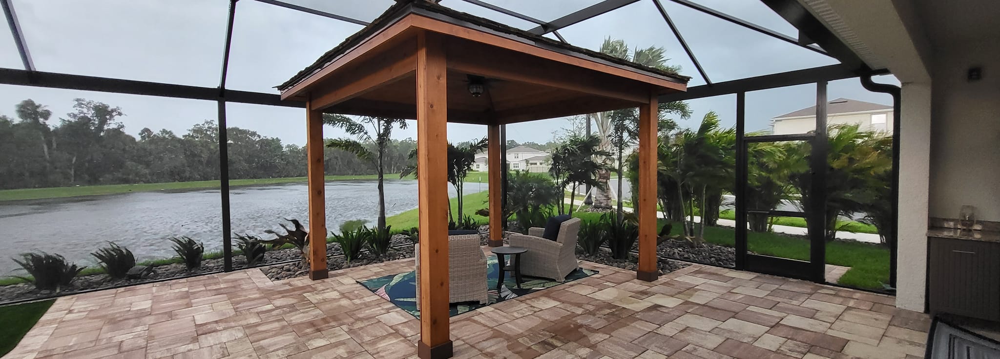 Outdoor gazebo overlooking lake and trees