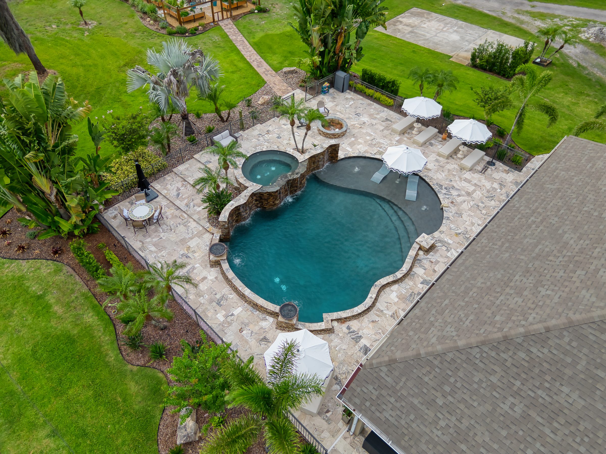 Aerial view of luxury backyard pool and patio.