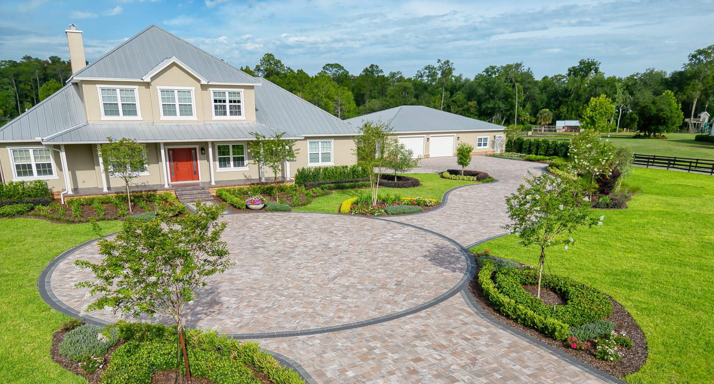 Spacious suburban house with landscaped driveway.