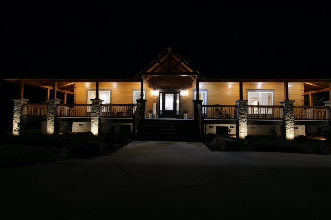 Illuminated wooden house exterior at night