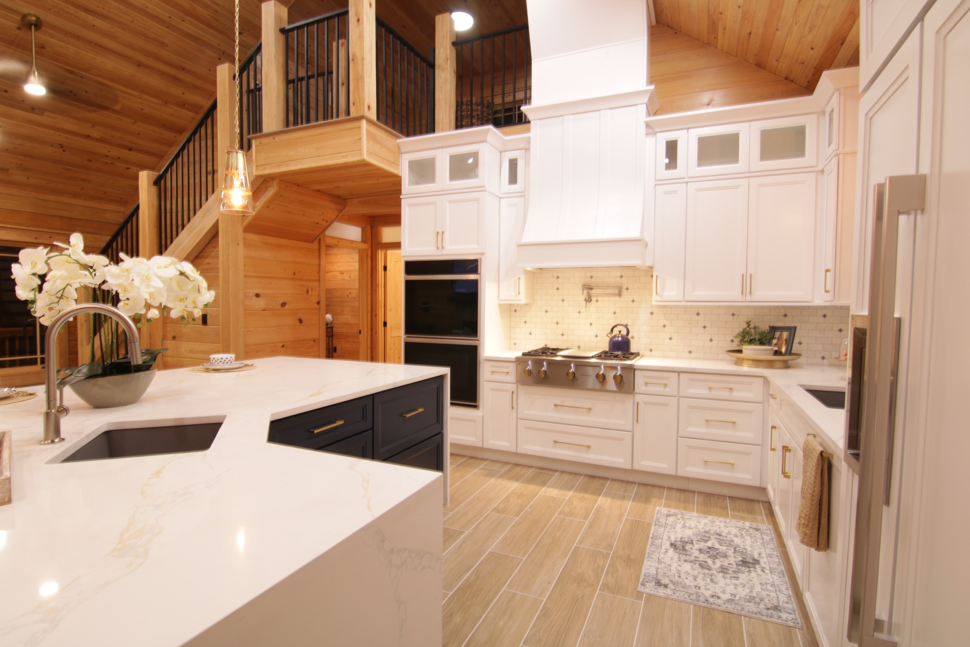Modern kitchen with wooden decor and white cabinets.