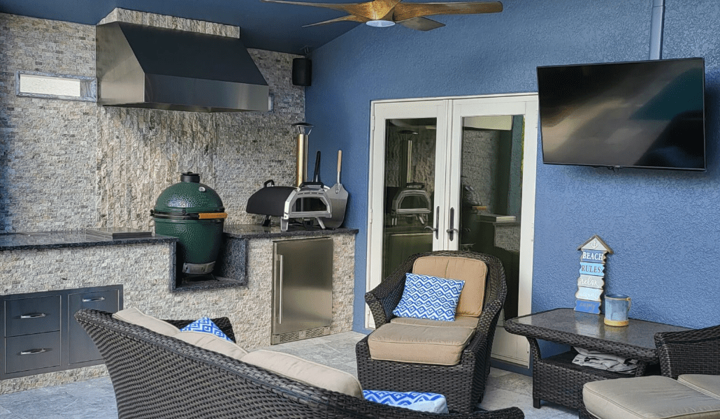 Outdoor patio with modern kitchen and seating area.