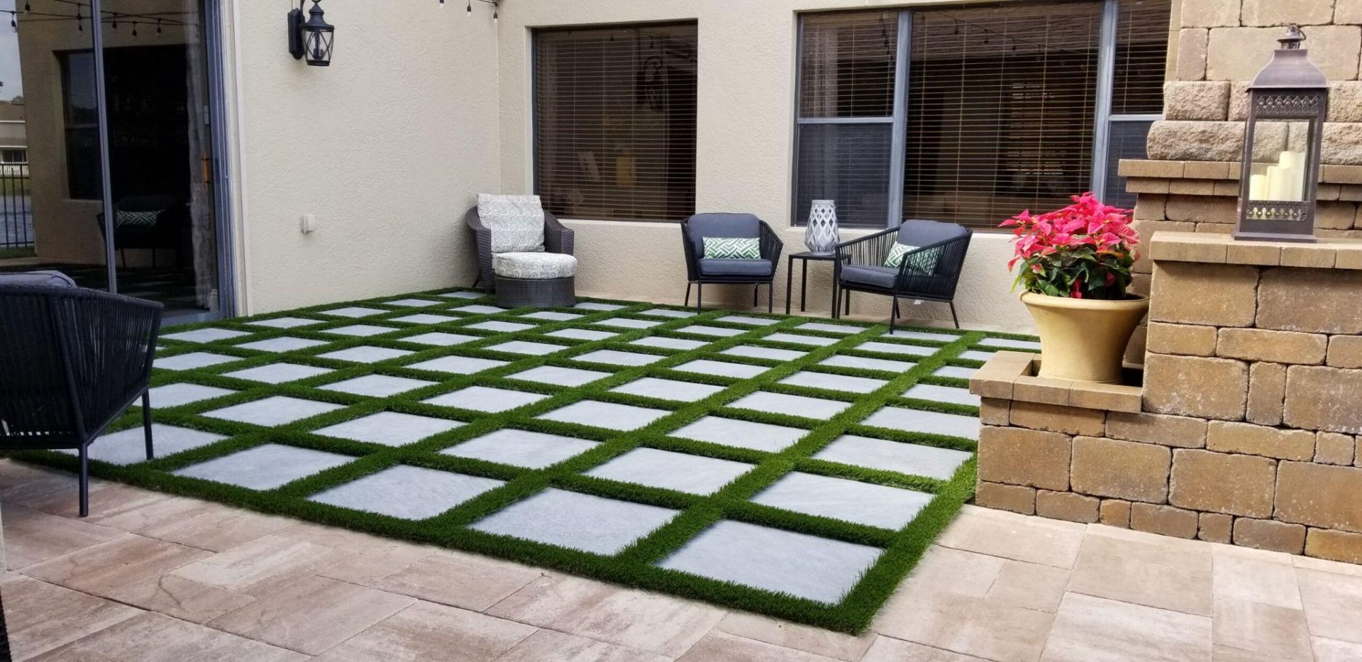 Contemporary patio featuring square concrete pavers set in a grass grid with outdoor seating.