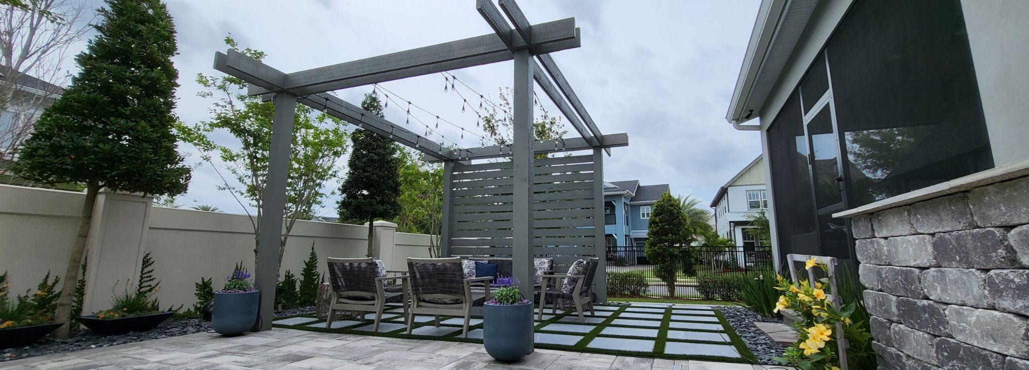 Modern pergola seating area with pavers and turf