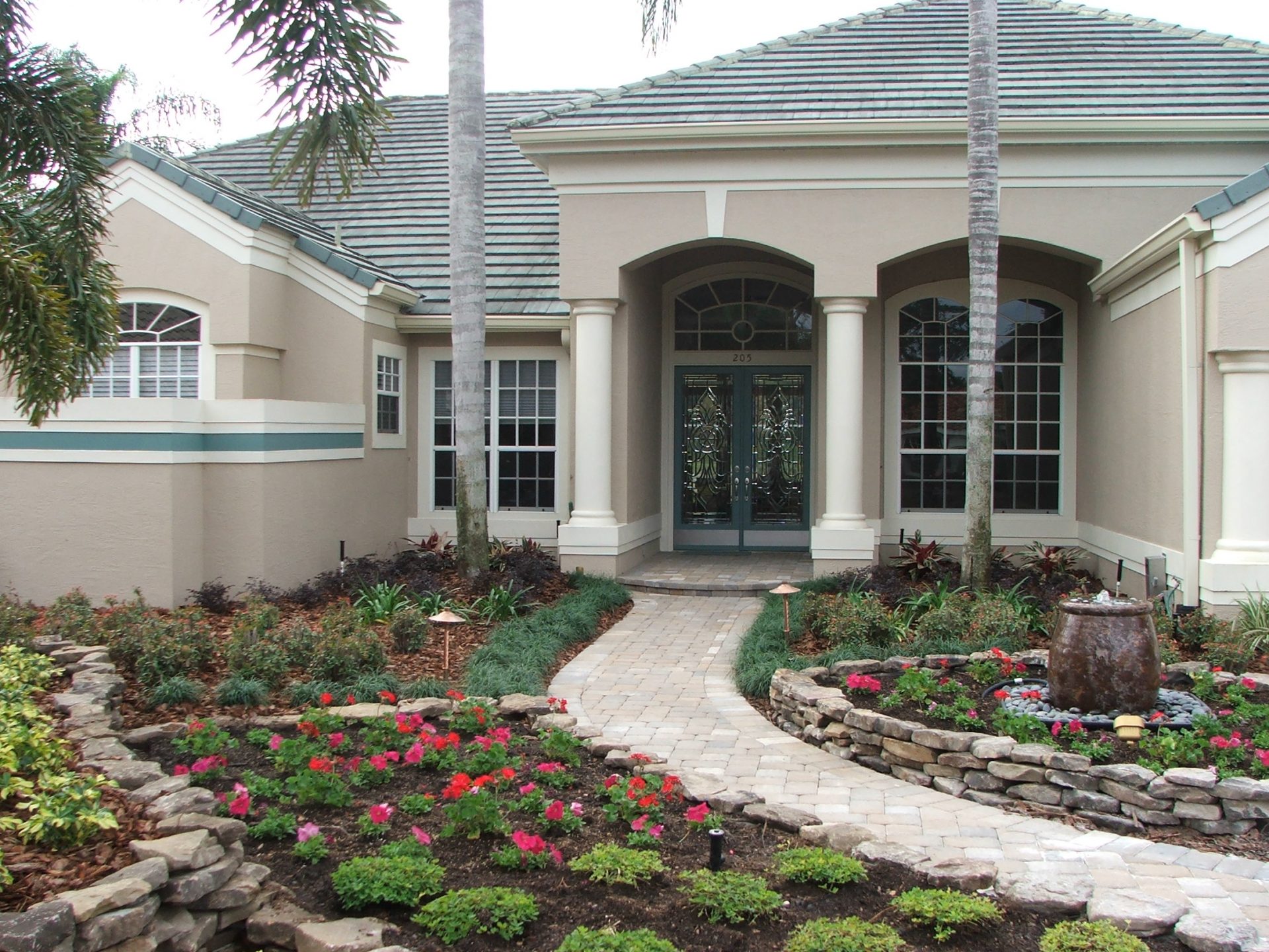 Elegant house entrance with landscaped garden.