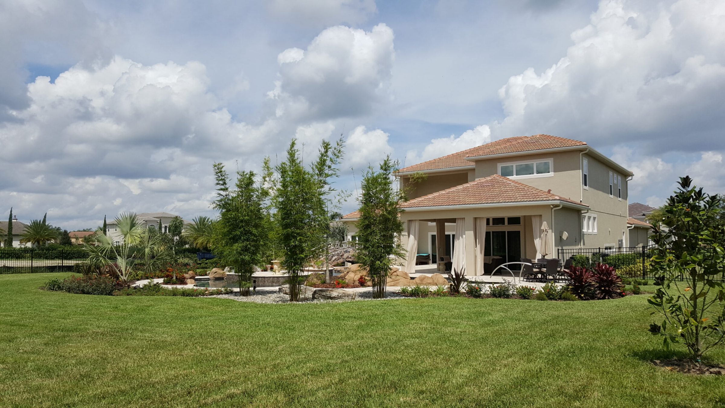 Modern suburban house with landscaped backyard.
