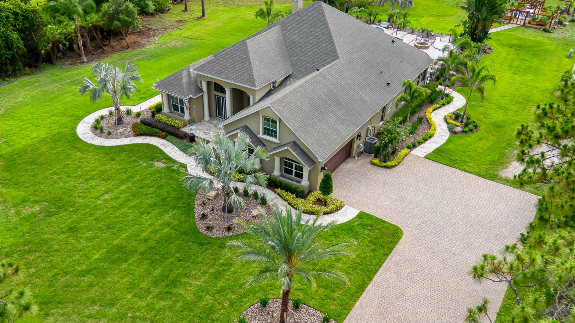 Aerial view of suburban house with green lawn.